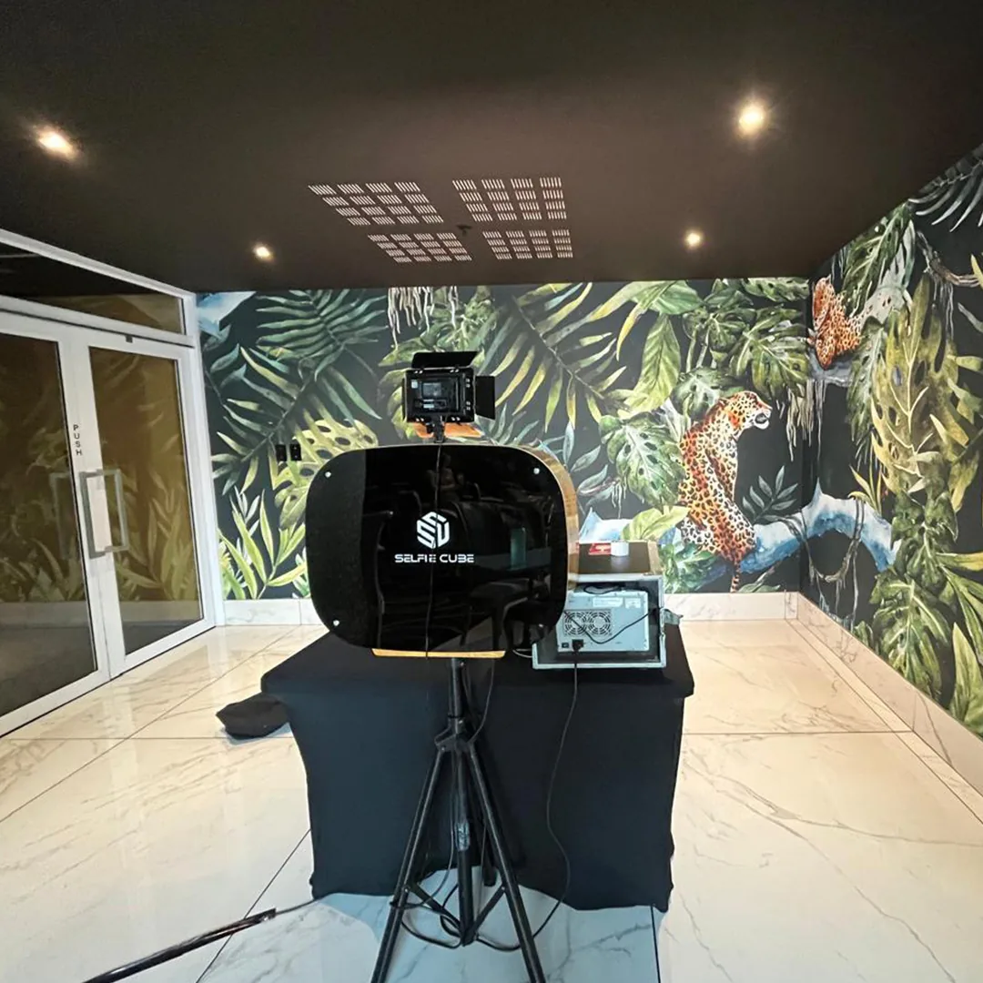 Botanical photo booth backdrop with soft event lighting