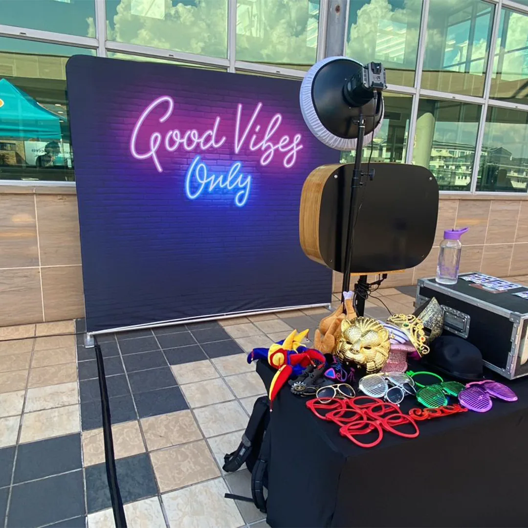 Photo booth prop table with glasses, signs and print samples