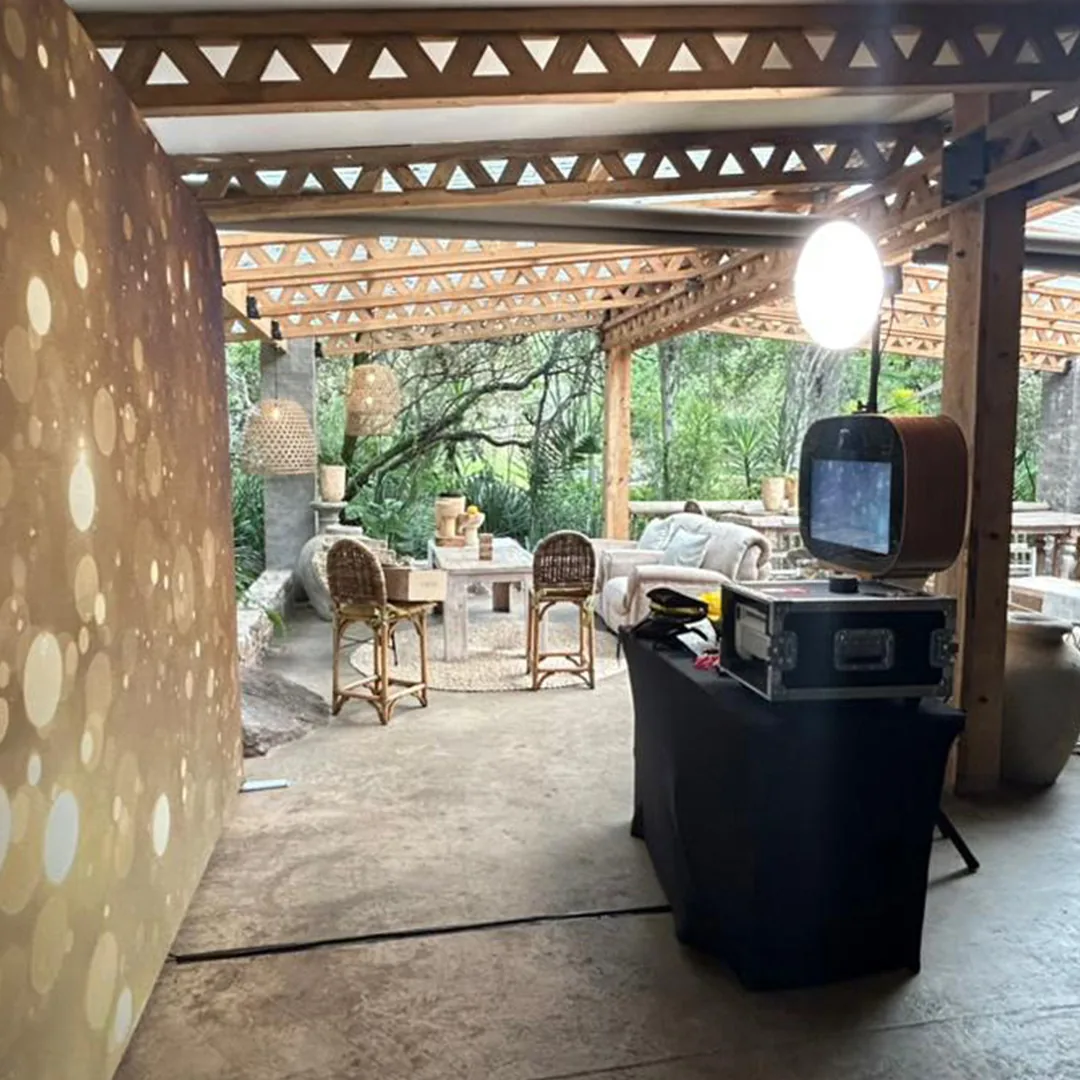 Photo booth camera, printer and backdrop prepared before guests arrive
